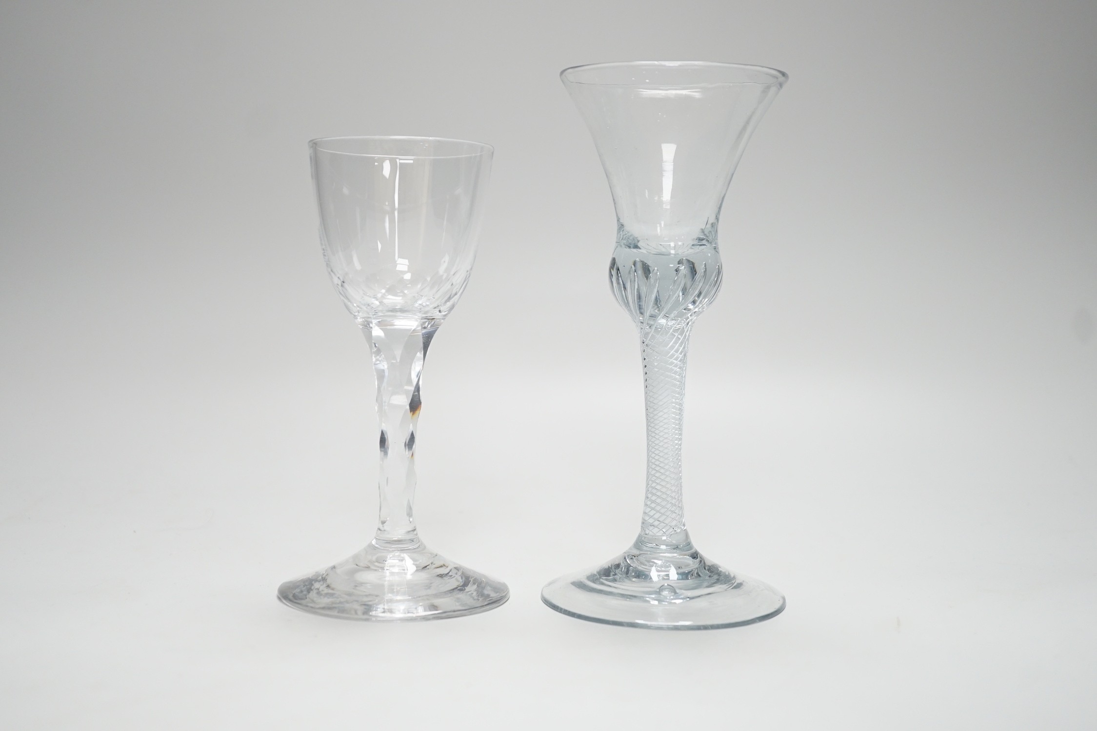 An 18th century air twist stem glass and a facet stemmed glass, tallest 18cms high